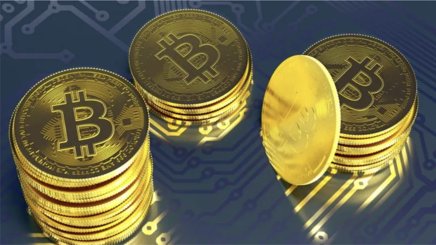Stacks of gold Bitcoin coins over a blue circuit-board background
